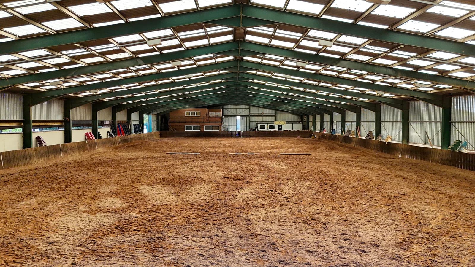 Full-length interior view of the international-size indoor riding arena at Trentvalley Equestrian Centre